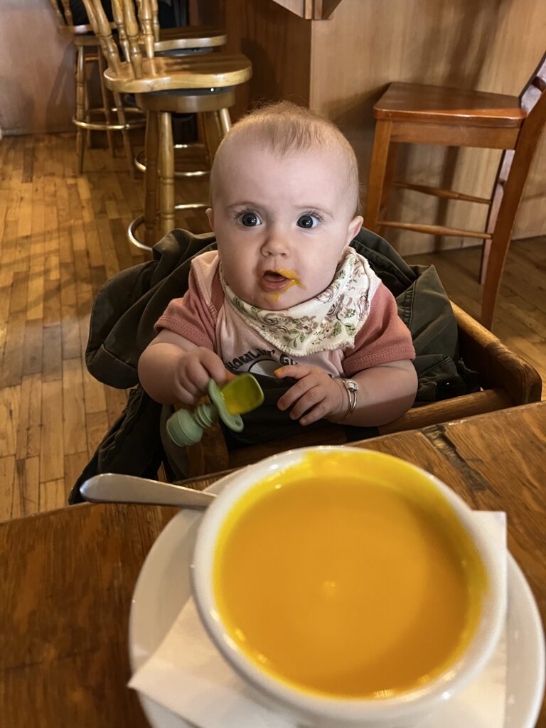 Lizzy eating carrot coconut soup at The Farm Bistro in Cortez, Colorado